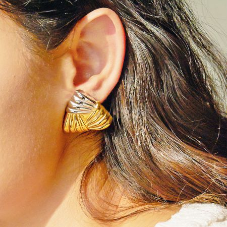 Detailed view of the two-tone chunky weave earring being worn, showing the contrast between gold and silver.