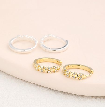 925 Sterling Silver Gold Flower Hoop Earrings - A set of 925 Sterling Silver Gold Flower Hoop Earrings, displaying both the gold and silver plated versions adorned with brilliant cubic zirconia stones.