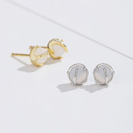 Top-down view of both the gold and silver white agate stud earrings, highlighting their classic design.