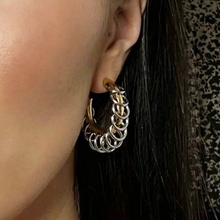 Close-up of the two-tone chain tassel hoop earring being worn, showcasing its punk-style aesthetic.