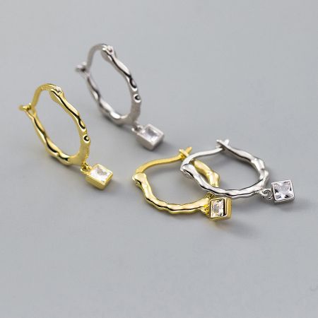 Comparison of the twisted square-cut zircon earrings in both gold and silver finishes.