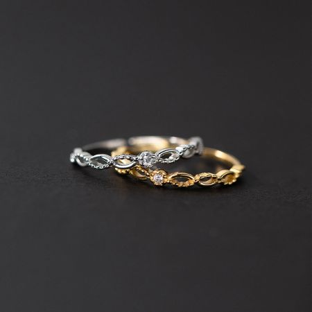 An artistic arrangement of the silver and gold lace rings from the set.