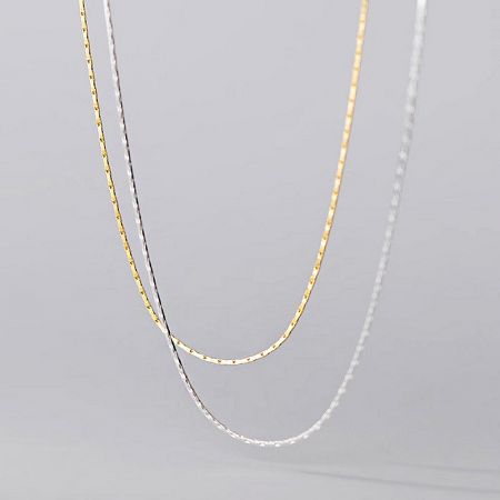 Wholesale 925 Sterling Silver Super Thin Snake Chain Necklace (Set of 5) - A close-up product shot of the 925 sterling silver super thin snake chain necklaces, showcasing both the gold and silver finishes and their delicate texture.