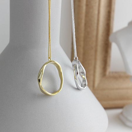 Both the 18K gold plated and 925 sterling silver necklaces displayed together to show the available options.