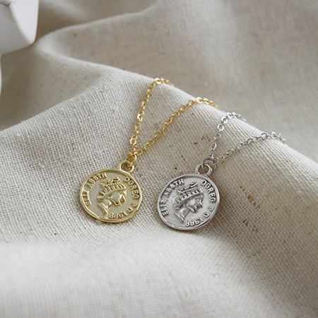 Both gold and silver vintage coin pendant necklaces displayed to show the retro portrait design.