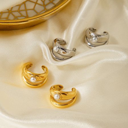 Detailed view of the gold and silver pearl ear cuffs.