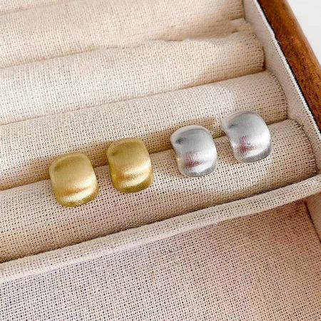 The complete set of vintage stud earrings presented in a jewelry box.