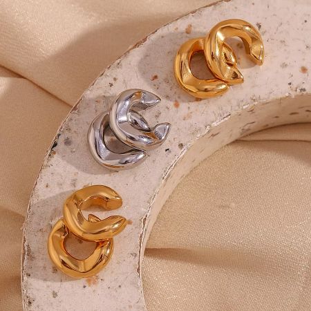 Three pairs of non-piercing ear cuff earrings showcasing the polished metallic finish.