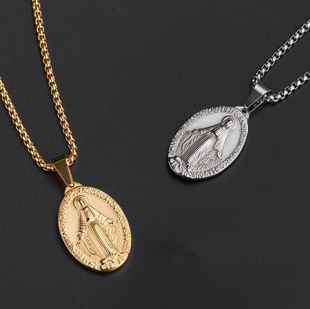 Two finely crafted religious pendants in gold and silver finishes, both featuring the Virgin Mary.