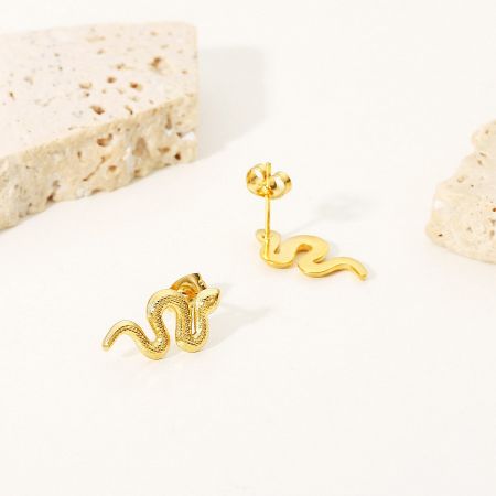Close-up showing the textured surface and post back of the gold snake earrings.