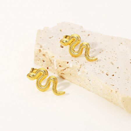 Stainless Steel Gold-Plated Distorted Snake Stud Earrings (Set of 5 Pairs) - A pair of gold-plated stainless steel snake stud earrings displayed on a textured beige stone, highlighting their unique distorted design.