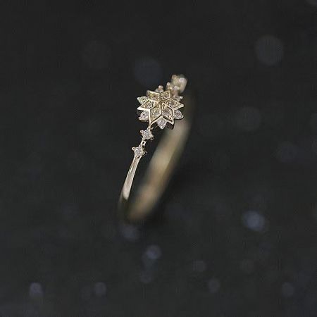 A luxurious gold version of the snowflake ring, showcasing its unique design and brilliant gemstones.