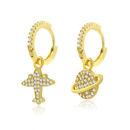 Detailed view of the gold space-themed earrings showcasing the airplane and planet charms.
