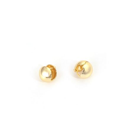 Side view of the gold round hoop huggie earrings, showcasing their minimalist and spherical design.