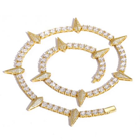 Close-up of a gold-plated iced out bracelet with a spiked design and brilliant CZ stones.
