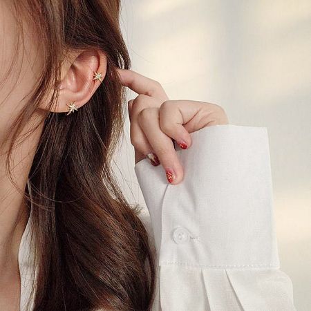 Lifestyle image showing the star ear cuff worn for a stylish look.