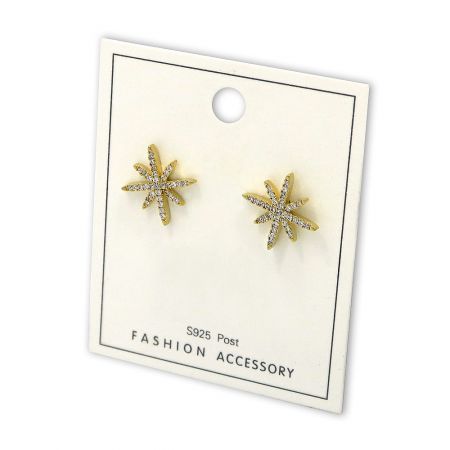 A pair of elegant gold star-shaped earrings with clear stones, presented as a chic fashion accessory.