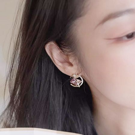 Model wearing the 14k gold-plated star stud earring to show scale and style.