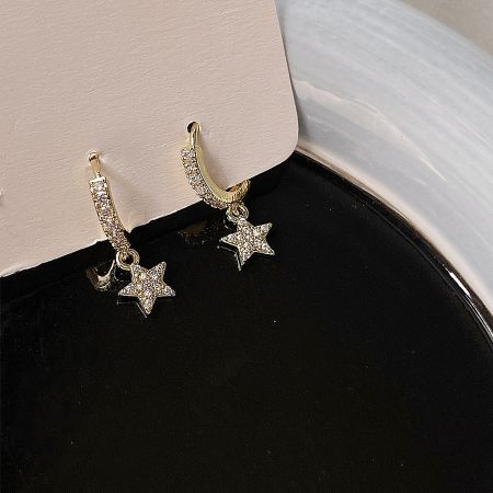 Detailed view of the 14k gold plated star drop earrings, highlighting the intricate cubic zirconia stone setting.