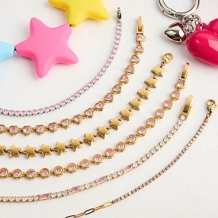 Wholesale Stainless Steel Jewelry Collection - A vibrant collection of JR Fashion Accessories' wholesale stainless steel jewelry, featuring gold-toned pieces with star and heart designs.