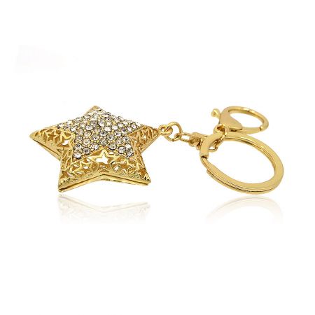 Detailed view of the intricate filigree design and rhinestone inlays on the gold star keychain.