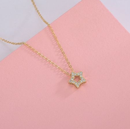 925 Sterling Silver Star Necklace - A detailed close-up of the 925 Sterling Silver Star Necklace, featuring a gold-plated star pendant set with brilliant white cubic zirconia stones.