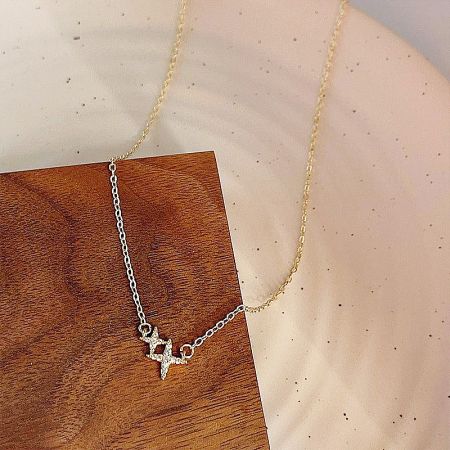 Lifestyle shot showcasing the gold-plated double-star collar necklace.