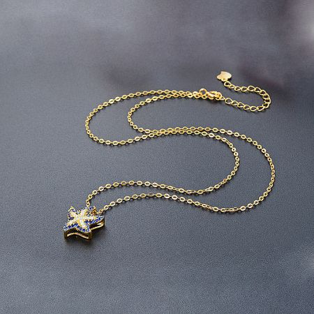 Another angle of the gold star necklace highlighting the brilliant blue gemstones.