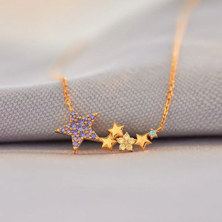 Detailed view of the gold star necklace showcasing various colorful gemstone accents.