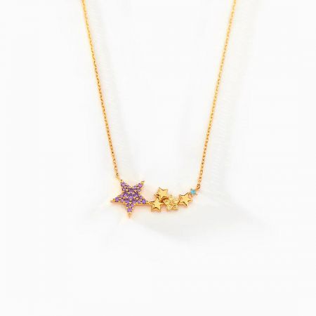 Full view of the celestial-inspired gold star necklace with multiple gemstone details.