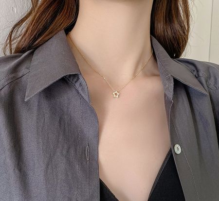 Model showcasing the 925 Sterling Silver Star Necklace to highlight its length and how it complements an outfit.