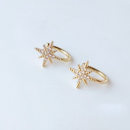 A pair of 14k gold plated starburst ear cuffs with sparkling clear gemstones.