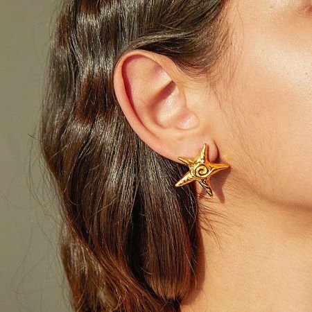Stainless Steel Waterproof 18K Gold Plated Star Stud Earrings - A close-up of a woman's ear wearing the elegant 18K gold plated stainless steel star stud earring, showcasing its brilliant shine and design.