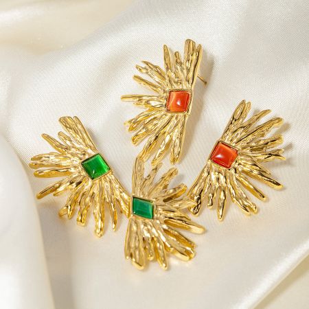 Detailed view of the gold fan-shaped earrings with intricate sunburst design.