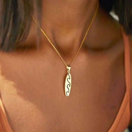 925 Sterling Silver Beach Wave Surfboard Pendant Necklace - Set of 5 - A model wearing the 925 sterling silver beach wave surfboard pendant necklace in a gold finish, showcasing its elegant design.