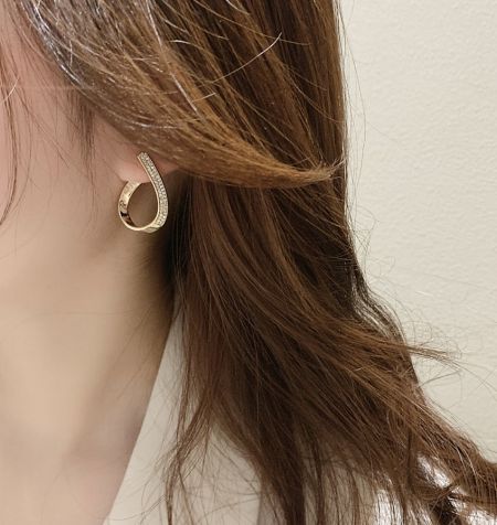 Close-up view of a single Tear Drop Crystal Earring, highlighting the gold plating and crystal detail.