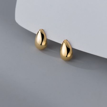 A pair of glossy gold water-drop stud earrings displayed on a clean white background.