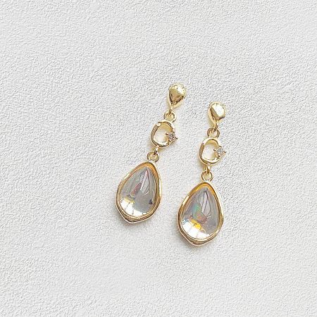 Front view of the gold teardrop earrings showcasing the clear gemstones.