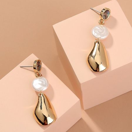 Front view of the gold teardrop pearl earrings showcasing the unique baroque shape and lustrous finish.