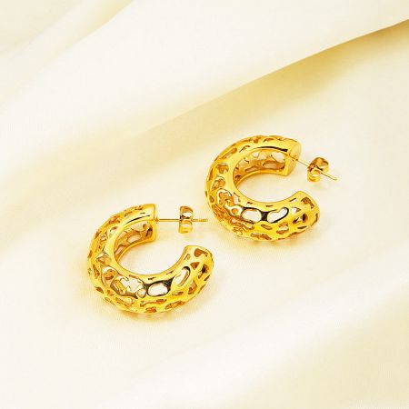 A pair of the hollow C-shaped gold earrings shown together to display their symmetrical design.
