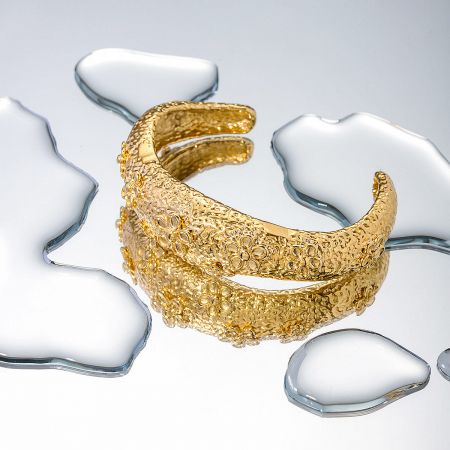 Stainless Steel Chunky Hammered Flower Pattern Opening Cuff Bangles Set of 5 - A set of five stainless steel cuff bangles with a chunky, hammered texture and floral pattern, finished in a brilliant gold tone.