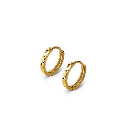 Close-up view of the gold hoop earrings, highlighting the intricate diamond-cut textured surface and shiny finish.