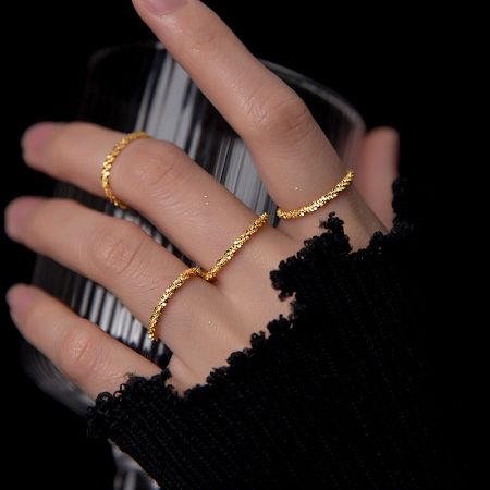 Model wearing the gold version of the sterling silver ring set.