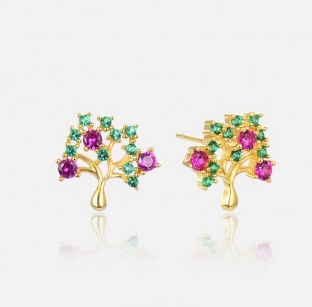 Close-up view of the gold-colored, tree-shaped stud earrings showcasing the intricate details of the pink and green gemstones.