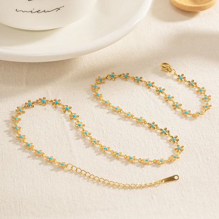 Detail of the matching bracelet with blue enamel flower charms.