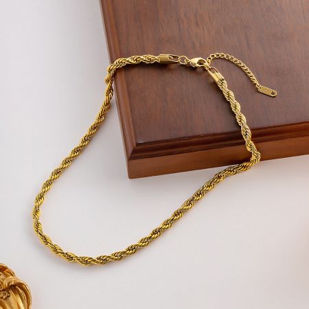 A bright, detailed image highlighting the texture and shine of the gold twisted chain necklace.
