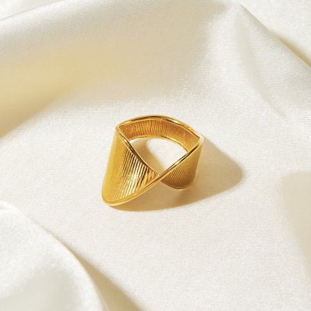 A bold gold-plated ring with a prominent twisted and ribbed texture.