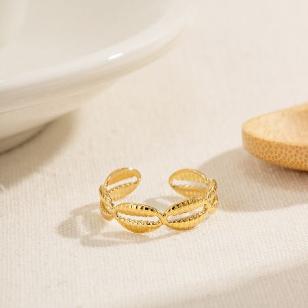 Detailed studio shot of a gold twisted design ring from the waterproof stainless steel set.