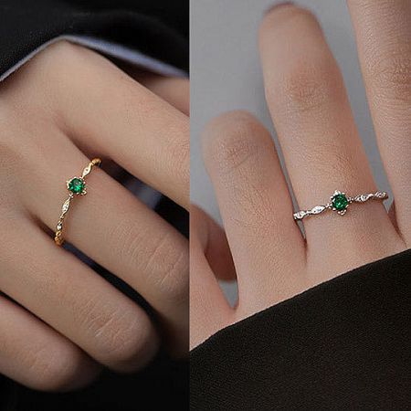 Side-by-side comparison of the gold and silver versions of the emerald zircon ring.