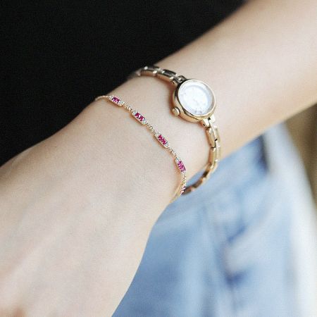 Fashion Women Charm Link Chain 925 Sterling Silver Ruby Bracelet (Set of 5) - A stylish 925 sterling silver charm bracelet with a pink ruby, elegantly worn on a wrist next to a gold watch, showcasing its versatile design.